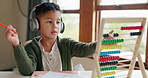 Abacus, math homework or child in kindergarten studying for knowledge, education or growth development. Alone, headphones or smart kid learning or counting on numbers to study for test in notebook 