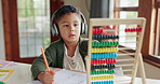 Home learning, math education or child in kindergarten studying for knowledge or growth development. Abacus, headphones or smart kid writing or counting on numbers to study for test in notebook 