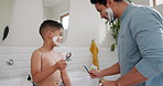 Teaching skincare, shaving cream and kid with dad in family bathroom for cleaning, routine or morning routine. Learning to shave, grooming together and child with father and playing with foam at home