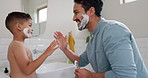 Learning about shaving cream, kid and dad teaching skincare in family bathroom with son in the morning. High five, grooming and happy child and parent relax or play with foam together at home