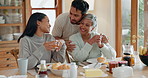 Hug, couple and family breakfast at a table at home for health and wellness. A mother with a married man and woman or friends together in dining room with love, care and conversation about food