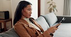 Woman, tablet and relax on sofa in living room for streaming online movie, ebook subscription or reading blog. Young female person on couch with digital technology, social media or search web at home