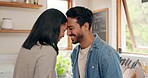 Love, hug and happy couple in a kitchen talking, together and intimate while bonding in their home. Embrace, romance and man with woman hugging, smile and sharing moment, conversation and laughing