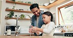 Girl washing her hands with her father in the kitchen for hygiene, health and wellness at home. Child learning to clean her skin with young dad with soap and water to prevent germs, dirt or bacteria.
