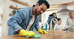 Family, cleaning and man in a kitchen with cloth for table, hygiene or clean living space after dinner. House, disinfection and guy parent with household chore for safety from bacteria, dirt or germs