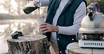 Hands, coffee and brew for camping, outdoor and energy to start morning in woods, forrest or nature adventure. Camper, pouring drink and kettle for matcha by lake, holiday or vacation in countryside