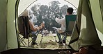 Couple, camping and tent with talking, morning and view with nature, forrest and relax in chair together. Man, woman and outdoor with back, conversation and pointing on holiday, romance and woods