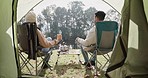 Relax, back and a couple camping in nature, watching the view and talking with coffee. Calm, travel and a man and woman drinking tea, speaking and looking at the forest while on a camp in the morning