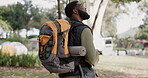 Travel, fitness and man backpacker hiking in a park or forest to explore an adventure, walking and trekking on a vacation location. Wellness, camping and young person or hiker relax in environment