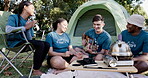 Music, dance and camping with volunteer friends sitting in a circle together for bonding. Guitar, smile and freedom with a group of young people having fun on their campsite in nature for charity