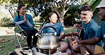 Guitar, dance and camp with volunteer friends sitting in a circle together for bonding. Music, smile and community with a group of young people having fun on their campsite in nature for charity