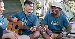 Guitar, fun and camping with volunteer friends sitting in a circle together for bonding. Music, smile and freedom with a group of young people dancing to songs on their campsite in nature for charity