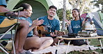 Guitar, dance and camping with volunteer friends sitting around a fire together for bonding. Music, smile and freedom with a group of young people having fun on their campsite in nature for charity