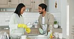 Man, woman and kitchen sink for washing dishes together, helping hand or happy chat in home with joke. Couple, cleaning and teamwork for bacteria, hygiene or smile for comic conversation in apartment