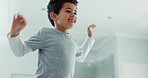 Kid, boy and jumping on bed in home while playing funny games with energy, freedom and laughing. Face of excited, happy and active young child bounce in air on furniture in house for movement of joy