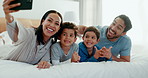 Family selfie, laughing and in a home bedroom for a memory, happy and comedy together. Smile, love and a young mother, father and children taking a photo on a bed in the morning for care and fun