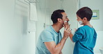 Shaving, bathroom and father teaching child about grooming, hygiene and facial routine. Happy, help and a young dad showing a boy kid cream or soap for hair removal together in a house in the morning