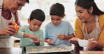 Grandmother, mom or children baking cookies in kitchen as a happy family learning cooking recipe at home. Support, child development or senior grandma helping or teaching kids with sprinkle on pastry