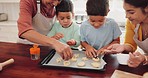 Baking, biscuits and kids with grandmother and mother in kitchen for sweet treats, dessert or snack. Sprinkles, bonding and boy children learning to decorate cookies with mom and senior woman at home