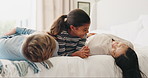 Parents, bed and child playing in a bedroom with mother and father as bonding with happiness together as a family. Happy, funny and kid with love or care for mom and dad in the morning at home