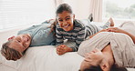 Happy family, bed and kid laughing in a bedroom with mother and father as bonding with happiness together as a family. Happy, funny and child with love or care for mom and dad in the morning at home