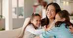 Mother, couch and hug with kids and parent care in a home with a smile from family love. Children, happy and mom on a lounge sofa in a living room with support and having fun together with youth