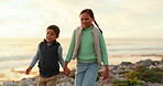 Children, holding hands and playing at beach for adventure, travel or holiday with energy and happiness. A young boy and girl, siblings or kids on a outdoor together for fun family vacation at sunset