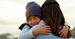 Security, mother and son hug outdoor, love and care at beach with travel and happiness in nature. Cold weather, winter and family, woman and young boy with smile, trust and safety with weekend trip