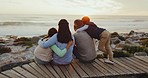 Parents, children and back at beach, sunset and watch together with hug, love and bonding on vacation in nature. Mom, dad and kids with care, view and peace by ocean on holiday, embrace and freedom