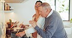 Food, laughing and a senior couple in the kitchen together, bonding while in their home to prepare a meal. Cooking, love or funny with a happy old man and woman getting cuisine ready for nutrition