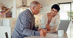 Talking, senior couple and insurance with laptop for budget website, banking or planning retirement. House, kitchen and elderly man and woman speaking about documents for a mortgage or loan with a pc