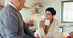 Senior couple, talk in kitchen with coffee and retirement, bonding with love and communication, laugh and happiness. Pension, funny story and man with woman at home, conversation and morning routine