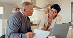 Talking, senior couple and bills with laptop for budget website, banking or planning retirement. House, kitchen and an elderly man and woman speaking about documents for a mortgage or loan with a pc