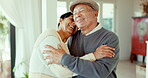 Love, elderly couple and hug in home, funny and bonding together for romance. Smile, senior man and woman embrace, happy laugh and enjoy time in retirement with care, affection and support for trust