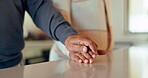 Closeup of couple, man and woman holding hands on table for love, care and trust together. Partner, loyalty and helping hand for kindness, sorry and commitment to support, hope and empathy to forgive