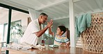 Laundry, high five and a grandfather teaching his grandchild how to fold clothes in the home for spring cleaning. Help, motivation or success with a young boy child and senior man inside for chores