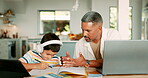 Education, laptop and a father teaching his son while at home for remote work or distance learning. School, homework or freelance with a man and boy child talking at the dining room table together