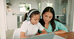 Kid, headphones and laptop with mother for homework with online app for development. Computer, child and parent is helping with elearning for education or virtual class for study in house with video.