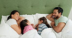 Morning, parents and children together in bed in a family home for comfort, quality time and bonding. A happy man, woman and girl kids in a bedroom for sleep, wake up or relax with love and care