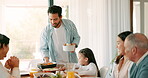 Thanksgiving, food and a man serving his family while eating food together for bonding in celebration. Love, lunch or brunch with a father carrying a dish to the dining room table during a holiday