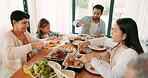 Children, parents and grandparents at thanksgiving together as a family eating food for bonding in celebration. Love, lunch or brunch with kids and relatives at the dining room table during a holiday
