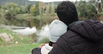 Young couple, hug and outdoor with back view, love and commitment, trust and safety together at lake. Bonding, support and care with date at nature park, man and woman with comfort and affection