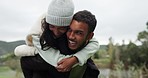 Young couple, piggyback and happiness outdoor with love and commitment, trust and safety together in forest. Bonding, support and care with man and woman on date at nature park and happy with hug