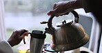 Kettle, pouring and boiling water into mug in morning on camping trip in kitchen with drink. Breakfast, holiday and hot beverage in thermos for hike in nature in close up with tea or coffee in cup.