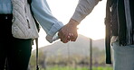 Couple, holding hands and love in nature for travel, care or trust in support together in the outdoors. Closeup of man and woman touching in partnership, reliable or romance for adventure or journey