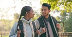 Hiking, conversation and couple in a forest walking, bond and relax outdoors together. Nature, walk and woman with man in the woods for hike, speaking and explore, adventure and backpacking travel