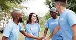 People, hands together and diversity in volunteer teamwork for eco friendly environment, success or mission outdoors. Group huddle, high five and team building, unity or support and trust in the park