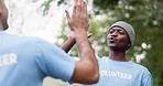 Happy black man, volunteer and high five for teamwork, community service or NGO in nature. People touching hands in team success, support or trust for mission, goals or cleaning park together outside