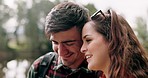 Hiking, couple smile and hug on adventure in forest together with a smile on travel and journey. Happy, young people and outdoor holiday in nature while walking on vacation with freedom and talk