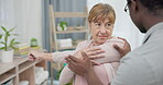 Physiotherapy consultation, stretching arm and old woman for rehabilitation, recovery or advice on injury healing. Physical therapy, black man and elderly patient listening to African physiotherapist